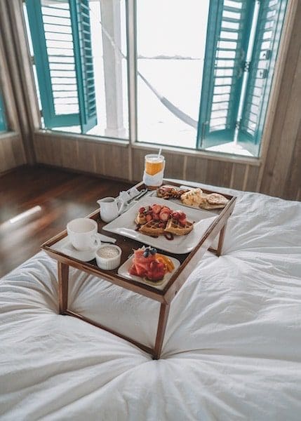 breakfast in bed tropical getaway paradise white sheets open window