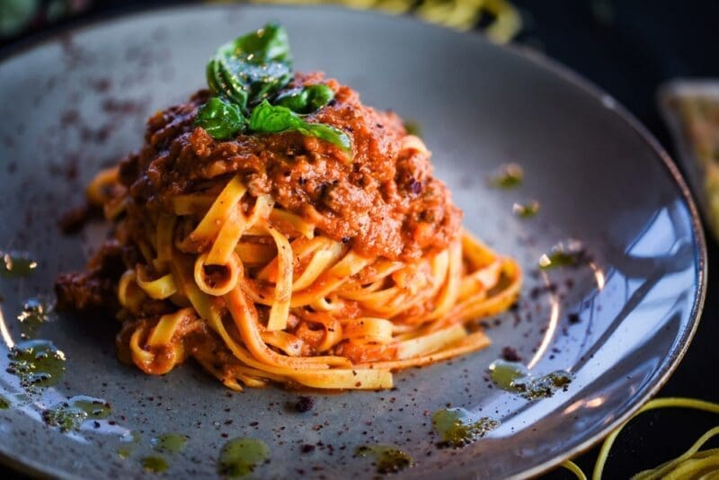 plate of pasta bolognese with olive oil drizzle