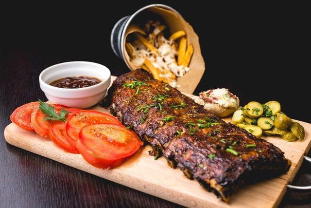 American steakhouse dinner with fries tomatoes