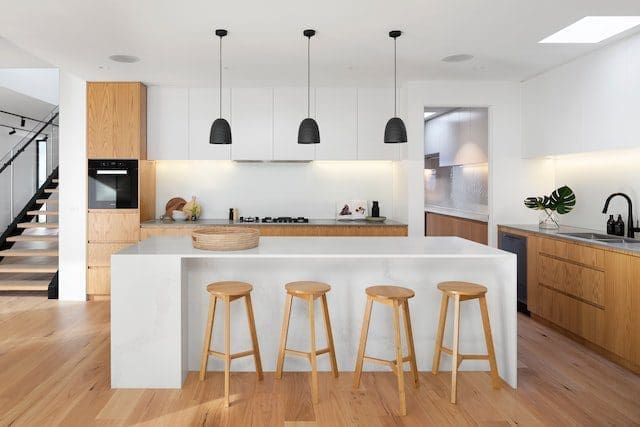 modern kitchen with wood flooring white cabinets