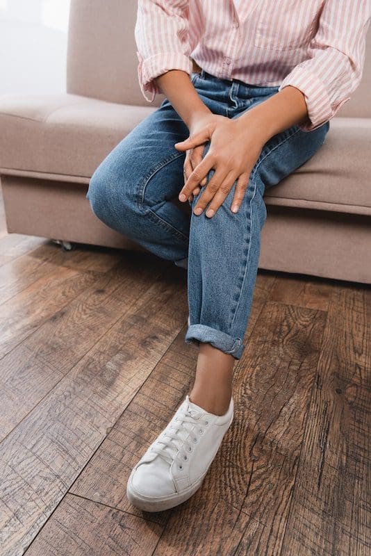 Partial view of african american woman suffering from knee pain