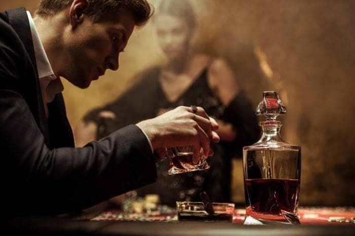 handsome man dressed up drinking glass of whisky