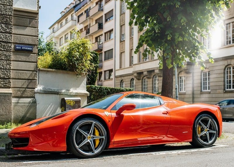 red luxury sports car parked on road