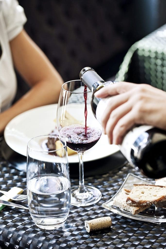 glass of red wine with dinner pour