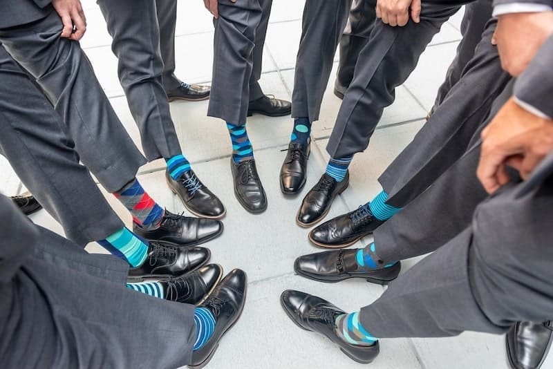 A high angle shot of the groomsmen standing in a circle