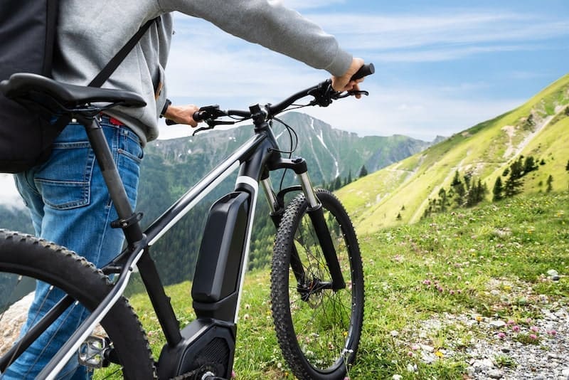 Man On Mountain With His Bike In Alps