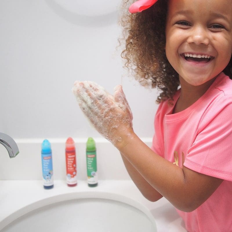 soapen girl playing at sink