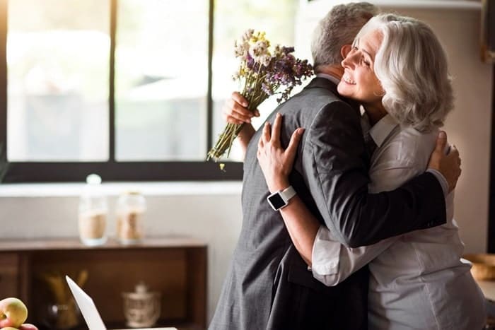 Happy elderly couple celebrating wedding anniversary