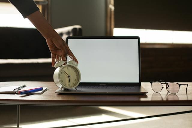 alarm clock next to computer