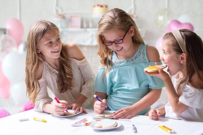 children decorating cookies for Easter