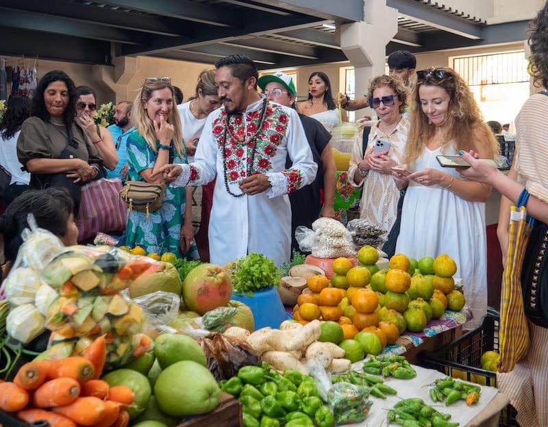 people at market in the Yucatan trying new food