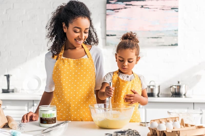 dignity coconuts mom and daughter cooking 