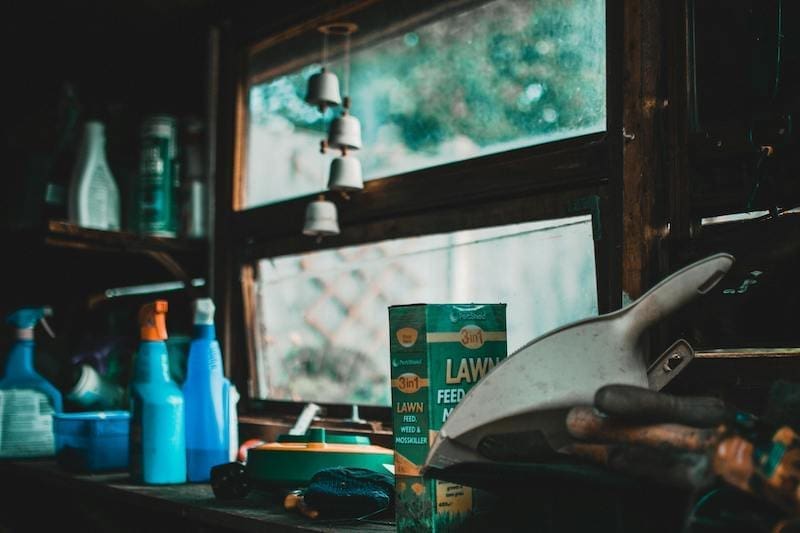 Green Lawn Box Beside Bottles and Window