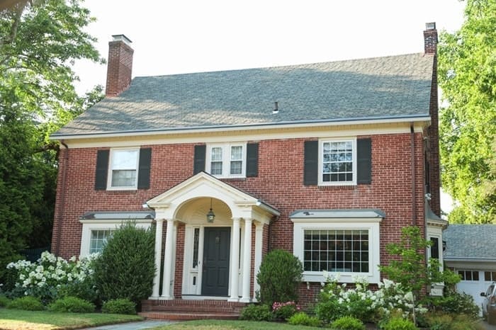 New home with brick walls and stone trim