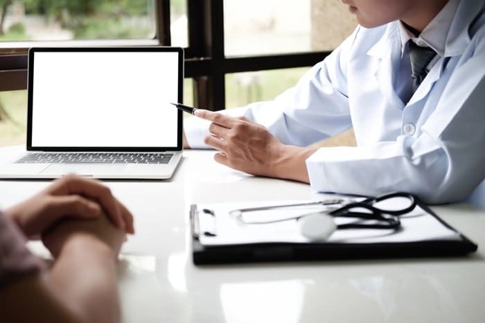 Doctor in white coat using HIPAA compliant fax services