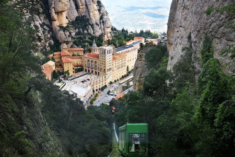 View of funicular and beautiful monastery Montserrat. Benedictine Abbey high up in the mountains near Barcelona, Catalonia, Spain.