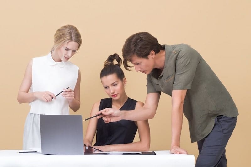 Employees collaborating on integrating email marketing with other digital strategies, focusing on creating a cohesive approach across platforms like social media and SEO